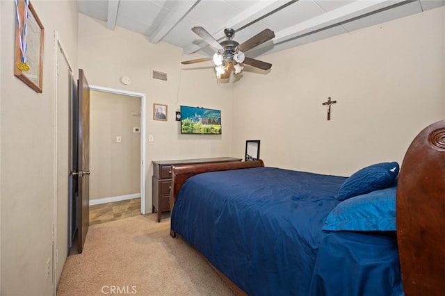 carpeted bedroom with ceiling fan and vaulted ceiling with beams