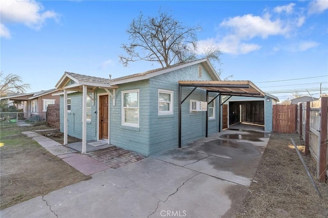 rear view of property with a carport