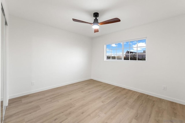 spare room with light wood-type flooring and ceiling fan