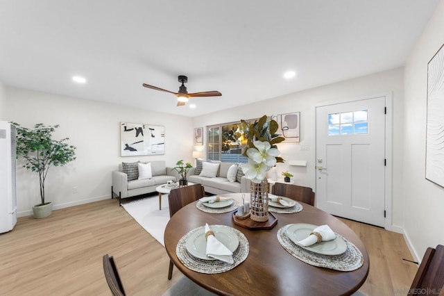 living room featuring light hardwood / wood-style floors and ceiling fan