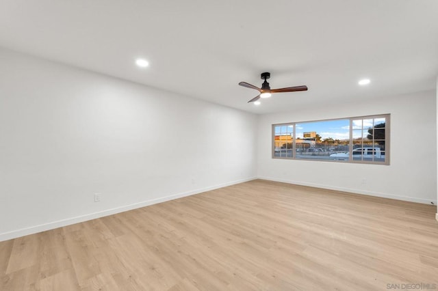 spare room with ceiling fan and light hardwood / wood-style flooring