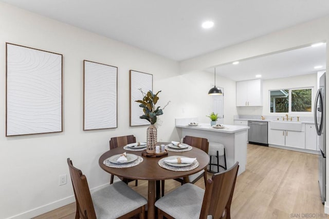 dining area featuring light hardwood / wood-style flooring and sink