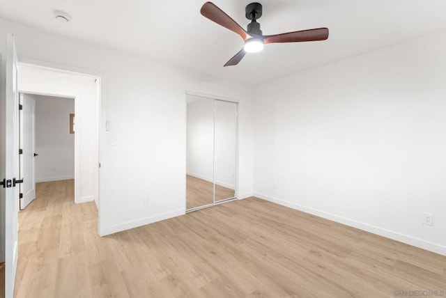 unfurnished bedroom with ceiling fan, a closet, and light hardwood / wood-style flooring