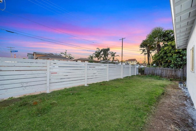 view of yard at dusk