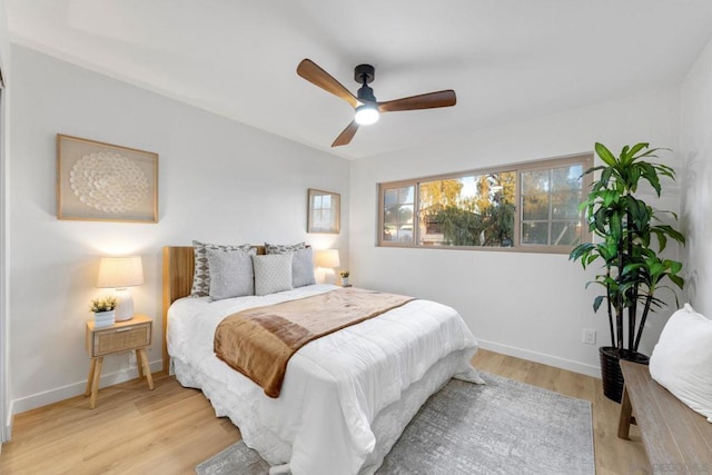 bedroom with ceiling fan and light hardwood / wood-style flooring