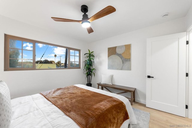 bedroom with ceiling fan and light hardwood / wood-style flooring