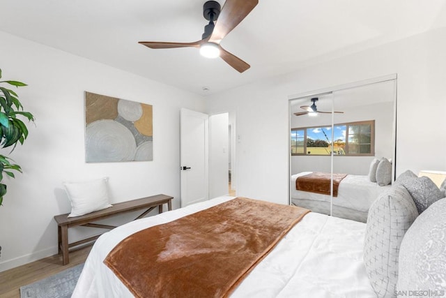 bedroom featuring ceiling fan, a closet, and hardwood / wood-style flooring