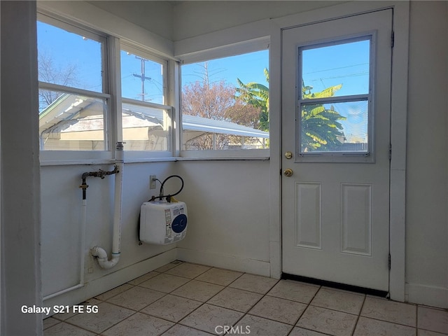 doorway with light tile patterned floors