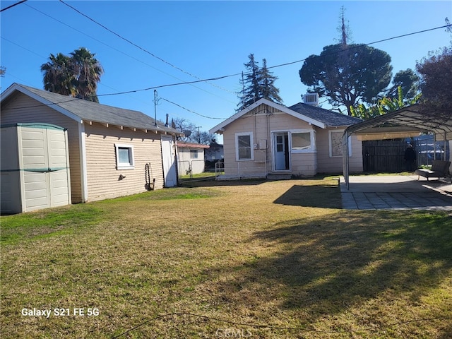 exterior space featuring a yard, a carport, and a storage shed