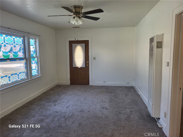 carpeted entrance foyer featuring ceiling fan