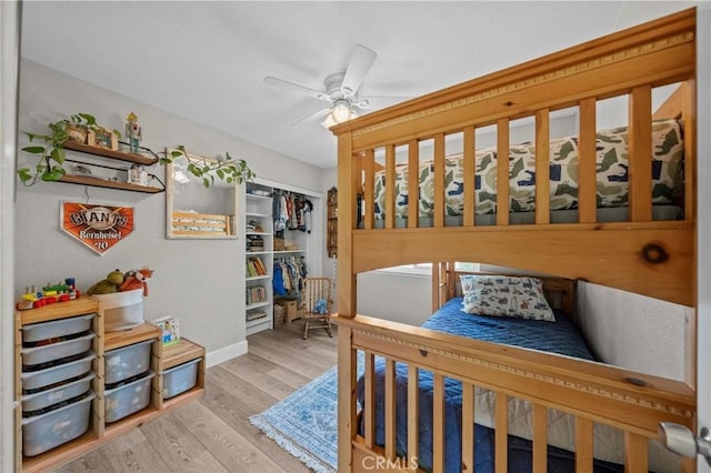 bedroom with a closet, ceiling fan, and light hardwood / wood-style floors