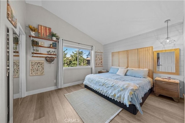 bedroom with lofted ceiling and light wood-type flooring