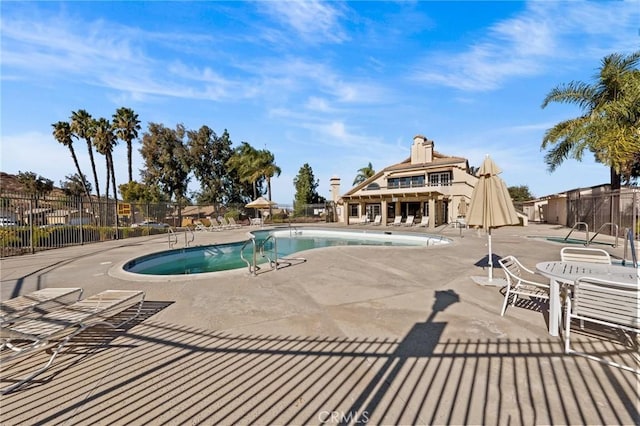 view of swimming pool with a patio