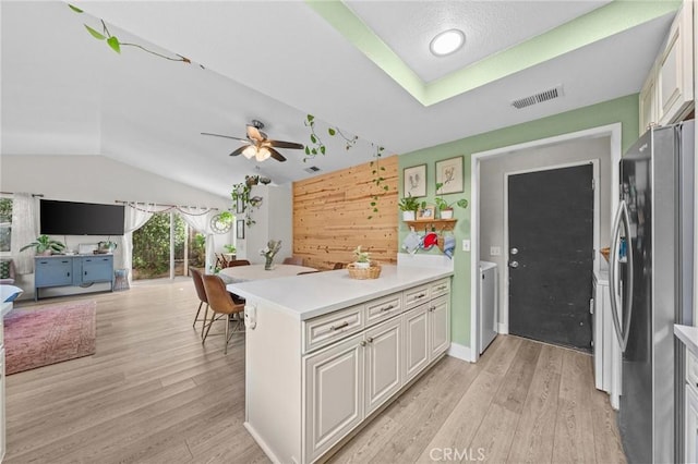 kitchen with stainless steel fridge, lofted ceiling, light wood-type flooring, white cabinetry, and ceiling fan