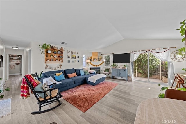 living room with hardwood / wood-style floors and vaulted ceiling