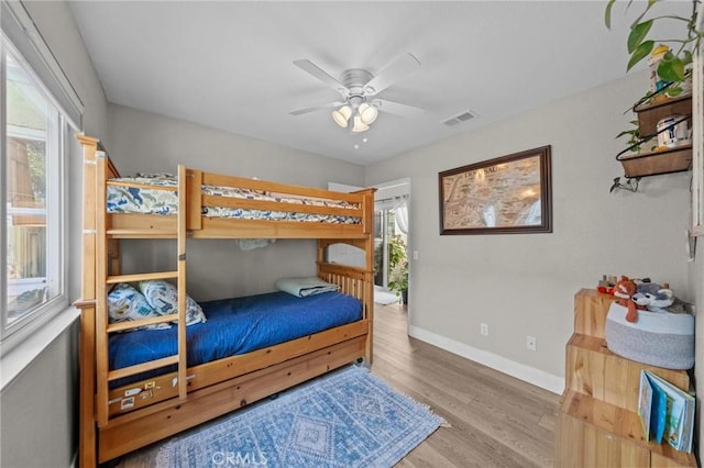 bedroom featuring multiple windows, ceiling fan, and light hardwood / wood-style floors