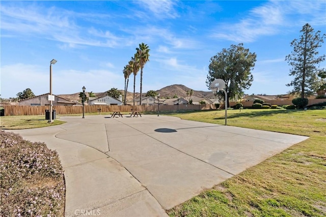 view of basketball court with a lawn