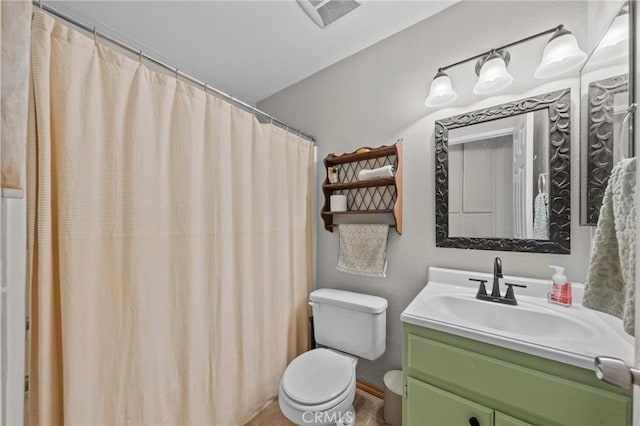 bathroom featuring curtained shower, vanity, and toilet