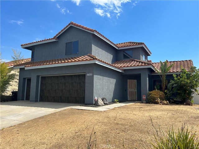 mediterranean / spanish-style home featuring a garage