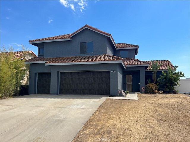 mediterranean / spanish home featuring a garage