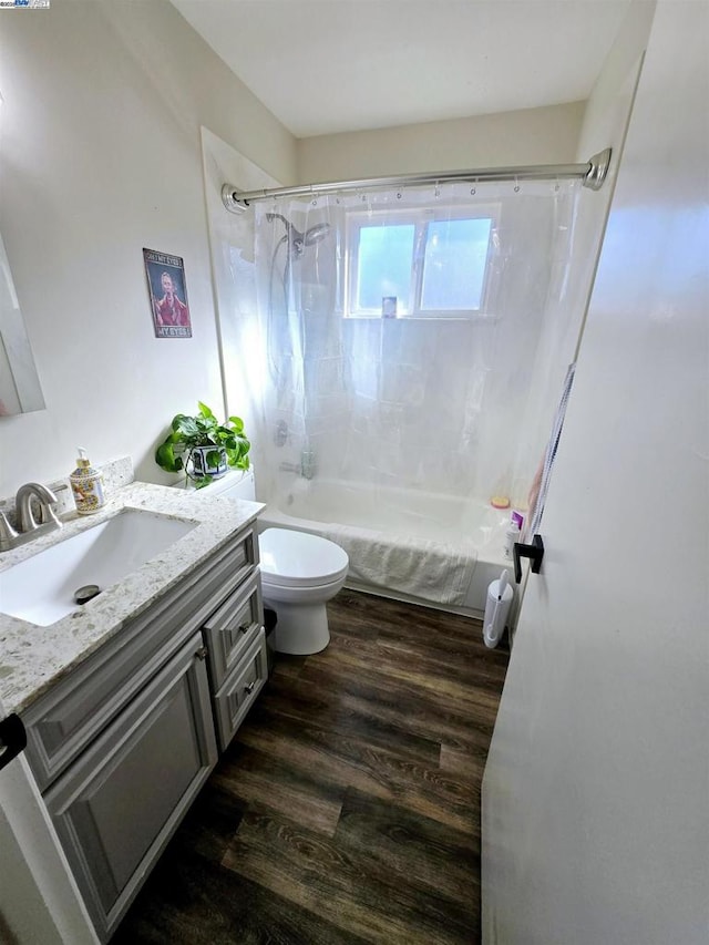 full bathroom with toilet, vanity, shower / bathtub combination, and hardwood / wood-style floors