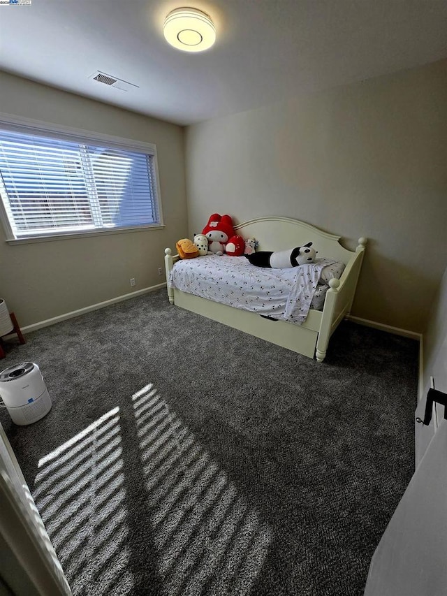 bedroom with dark colored carpet