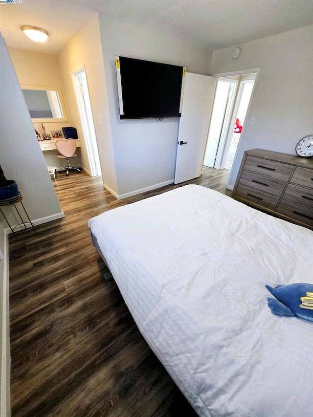 bedroom with dark hardwood / wood-style floors