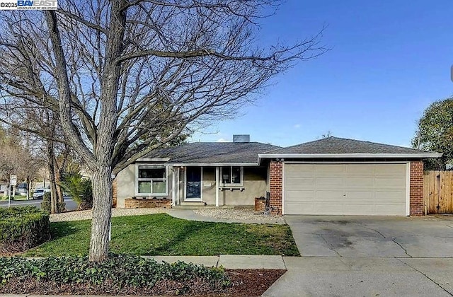 ranch-style house featuring a garage and a front lawn