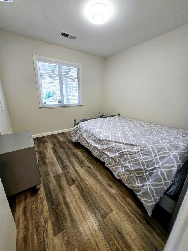 bedroom featuring dark hardwood / wood-style flooring