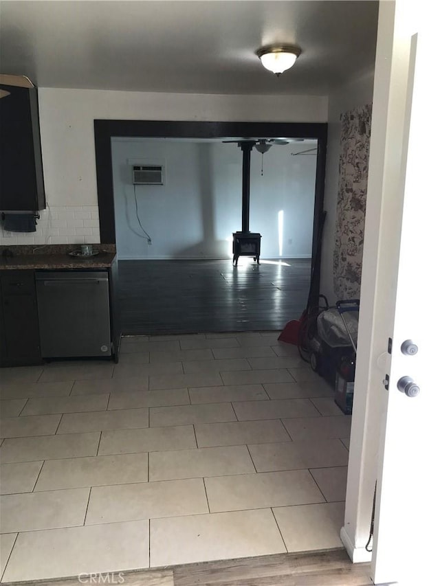 hall with a wall unit AC and light tile patterned floors