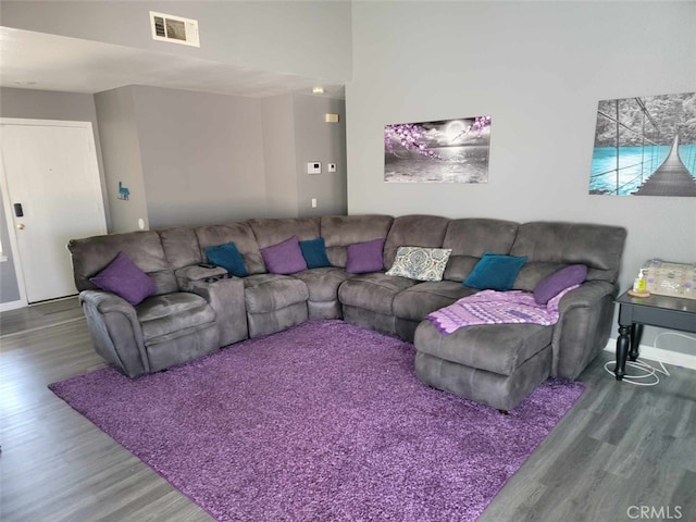 5542 Aster St, San Bernardino, CA 92407 - living area with visible vents, baseboards, and wood finished floors
