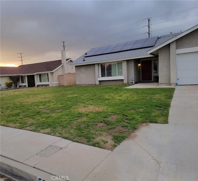 5542 Aster St, San Bernardino, CA 92407 - ranch-style house featuring stucco siding, solar panels, a front yard, and a shingled roof