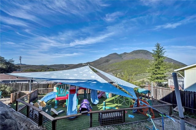 view of dock featuring a mountain view and a playground