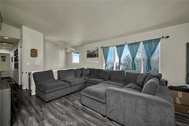 living room with ceiling fan and dark hardwood / wood-style flooring