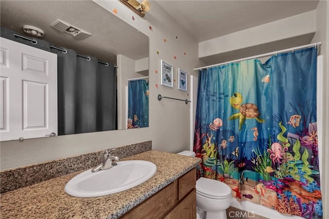 bathroom featuring vanity, curtained shower, a textured ceiling, and toilet