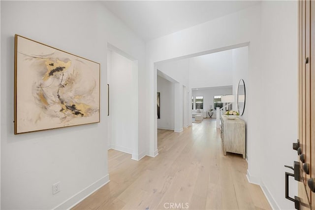 hallway with light hardwood / wood-style flooring