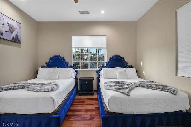 bedroom with ceiling fan and dark hardwood / wood-style floors