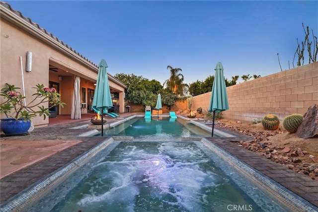 view of swimming pool featuring an in ground hot tub