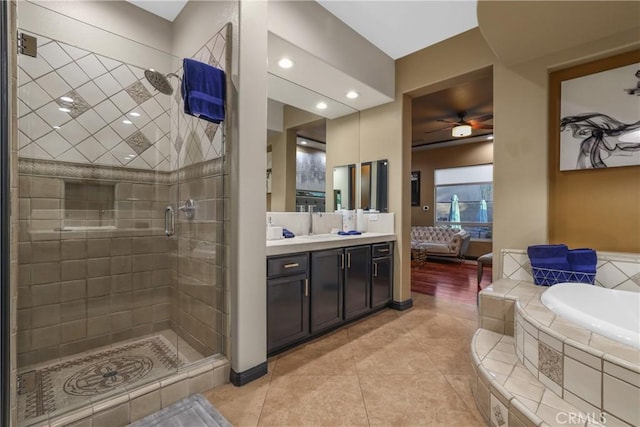 bathroom with shower with separate bathtub, ceiling fan, tile patterned floors, and vanity