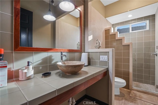 bathroom with backsplash, vanity, and toilet