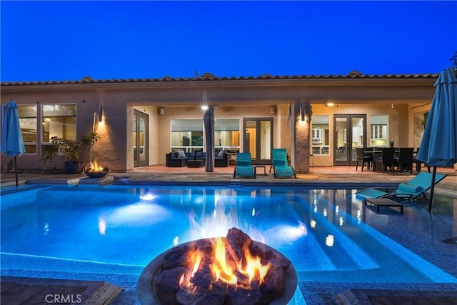 view of pool featuring a patio and an outdoor fire pit