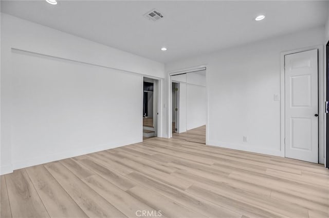 empty room with light hardwood / wood-style flooring