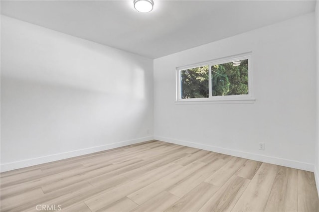 spare room featuring light wood-type flooring