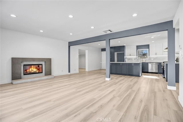 living room featuring a fireplace and light wood-type flooring