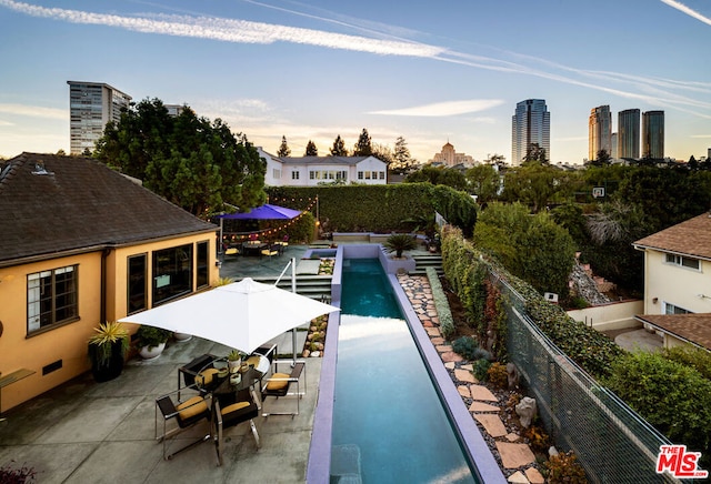 view of swimming pool with a patio