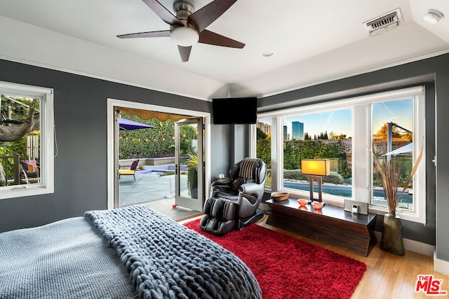 bedroom featuring access to outside, hardwood / wood-style flooring, and ceiling fan