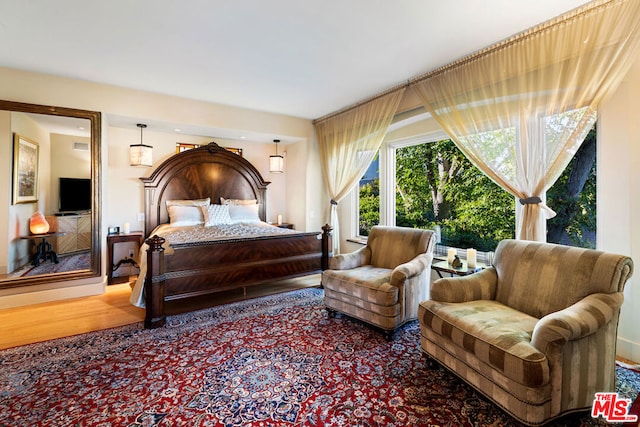 bedroom with hardwood / wood-style flooring