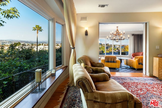 living room with wood-type flooring and a chandelier