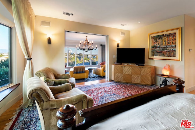 living room featuring hardwood / wood-style floors and an inviting chandelier