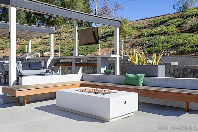 view of patio / terrace with an outdoor living space with a fire pit